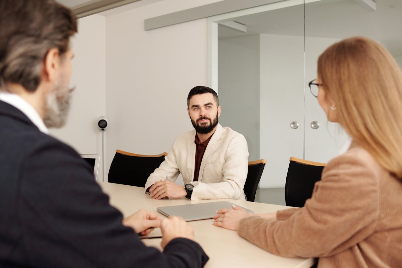 Professional business meeting with diverse team members in an office setting.